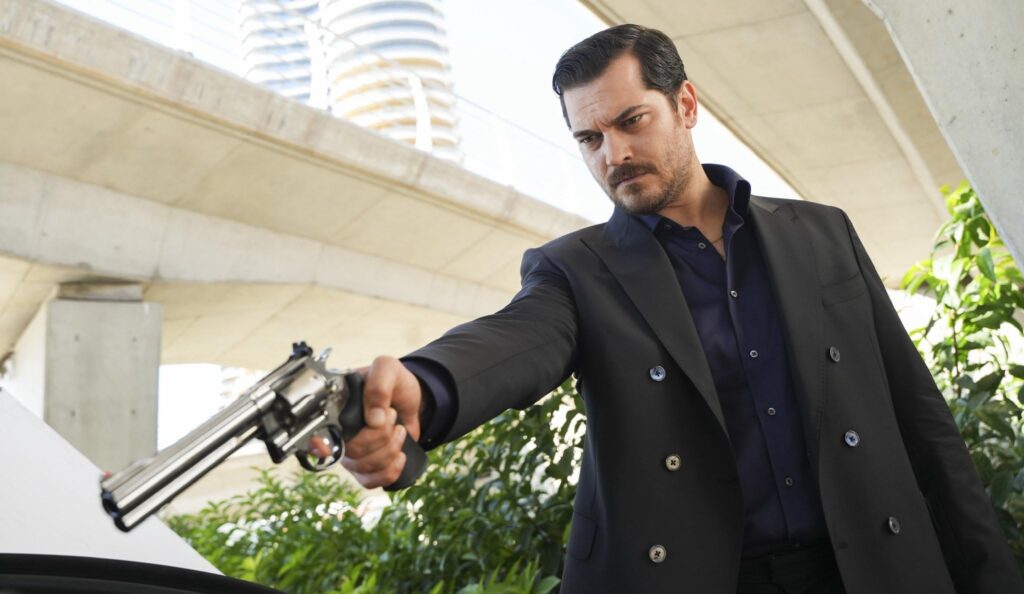 Eşref Rüya main character Nisan in a wedding dress holding a pistol, from the Turkish drama series.